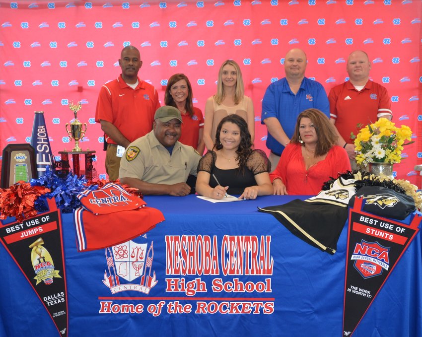 At her signing ceremony are, front row, from left, her dad, Vince Carter; Lexxi Carter; and her mom, Jeannie Smith; second row, from left, Assistant Principal, LaShon Horne; Assistant Principal, Dana McLain; Cheer Coach, Nikki Morrow; Principal Jason Gentry; and Assistant Principal, Brent Pouncey.
